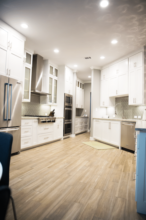 Large white kitchen with glass doors